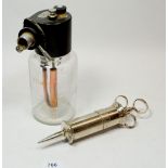 A medical ether bottle and ear syringe