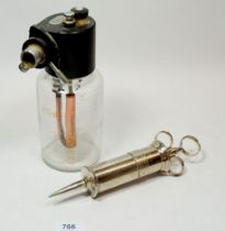 A medical ether bottle and ear syringe