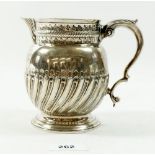 A silver jug with half reeded decoration, 318g, London 1909 by C S Harris & Sons Ltd, 12.5cm