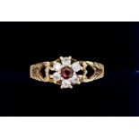 A 9 carat gold ring set white stones and garnet, size O to P