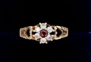 A 9 carat gold ring set white stones and garnet, size O to P