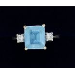 An 18 carat white gold Art Deco style blue topaz and diamond ring, size R to S