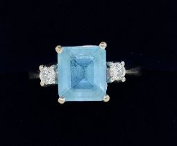 An 18 carat white gold Art Deco style blue topaz and diamond ring, size R to S