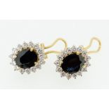 A pair of 18 carat gold sapphire and diamond cluster earrings with chips and pierced fittings