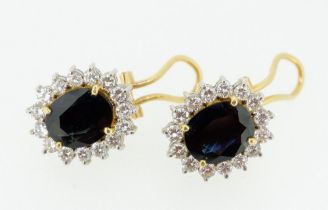 A pair of 18 carat gold sapphire and diamond cluster earrings with chips and pierced fittings