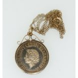 A 9ct gold scroll top coin mount on a fine 9ct gold chain containing a 1977 Silver Jubilee