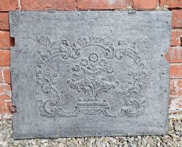 An antique cast iron fire back with floral and scrollwork decoration, 72 x 58cm