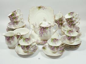 A Royal Standard Wisteria tea service comprising: twelve cups and saucers, twelve tea plates,