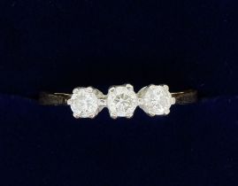 An 18 carat gold three stone diamond ring, size N