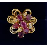 A vintage gold asymmetrical ring set six oval cut rubies and five chip diamonds, size R to S