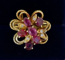 A vintage gold asymmetrical ring set six oval cut rubies and five chip diamonds, size R to S