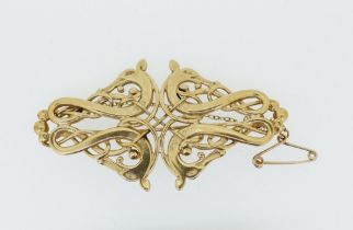 An Ola Gorie Celtic 9 carat gold openwork dragon brooch, 11g