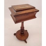A late Regency rosewood teapoy with sarcophagus form top raised on turned and carved column on