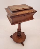 A late Regency rosewood teapoy with sarcophagus form top raised on turned and carved column on