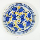 A 19th century Delft large dish painted blue and yellow flowers and foliage, monogrammed R.C, 34cm