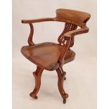 An Edwardian swivel mahogany desk chair with pierced vase splat