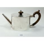 A Victorian silver Arts & Crafts Garrards teapot of plain oval form with wooden handle and finial,