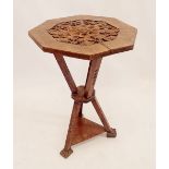 A Victorian walnut carved octagonal gypsy table on triple carved gothic supports