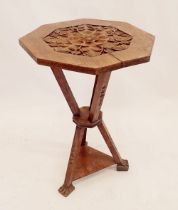 A Victorian walnut carved octagonal gypsy table on triple carved gothic supports