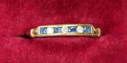 A 9 carat gold ring set sapphires and three diamonds, size P to Q