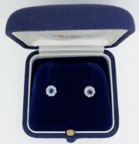 A 9 carat white gold pair of sapphire and diamond earrings (studs) 6mm total diameter