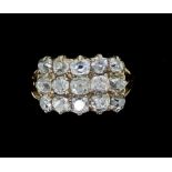 An 18 carat gold Georgian style diamond ring set fifteen old cut diamonds in three rows, size M,