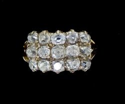 An 18 carat gold Georgian style diamond ring set fifteen old cut diamonds in three rows, size M,