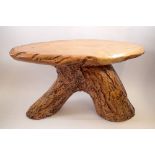 A rustic wooden occasional table on trunk supports, 32cm tall