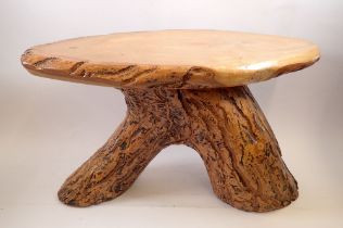 A rustic wooden occasional table on trunk supports, 32cm tall