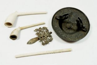 A continental cast metal ashtray, three clay pipes and a silver plated chatelaine top