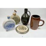 A brown glazed pottery flask, a Swiss blue and white flask, large brown tankard, a Fulham Pottery