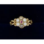 An Edwardian 18 carat gold cluster ring set seed pearls and ruby, size G