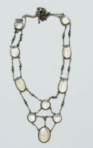 An Edwardian Arts & Crafts silver and moonstone necklace, chain needs minor repair