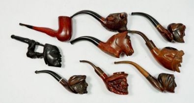 A collection of nine character and novelty smoking pipes including a hand carved ladies leg example