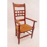 A 19th century spindle back rush seated chair with spindle front rail
