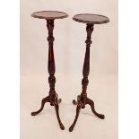 A pair of mahogany carved torchere stands 107cm tall