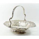 A Victorian silver basket with shell and floral embossed decoration and pierced trellis panels,