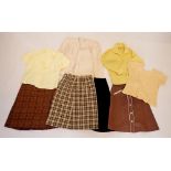 A box of vintage clothing including two tweed skirts