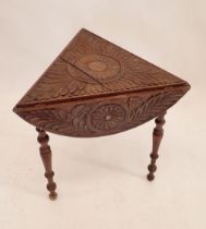 A Victorian circular carved occasional table folding down to make a triangle, 66cm diameter