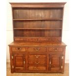 A Georgian oak Welsh dresser, the three tier back with four spice drawers all over base with