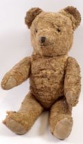 An old gold plush straw filled teddy bear, 36cm tall