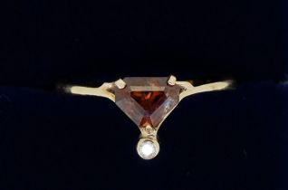 A 9 carat gold ring set orange stone - a/f and chip diamond, size O, 2g