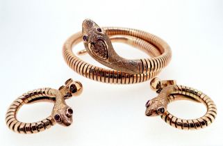 A vintage 9 carat gold coiled snake bracelet and pair of matching earrings all set ruby eyes, 32g,