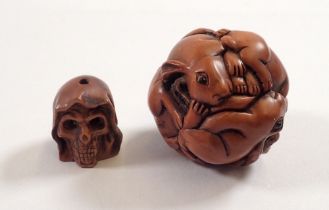 A Japanese carved wood rabbit netsuke and a similar small skull