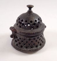 An antique circular Islamic bronze censer box with pierced decoration to body and hinged lid, 10cm