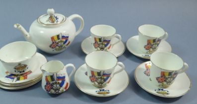 A WWI Armistice Day child's tea service comprising teapot, milk jug and four cups and saucers