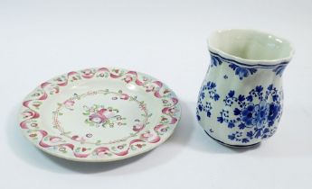 An antique faience plate painted flowers in pink ribbon border, 17.5cm diameter and a Delft vase,