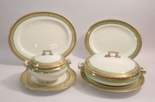 A Cauldon China dinner service with green and gilt borders comprising: twelve dinner plates,