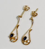An 18 carat gold pair of pendant earrings set two diamonds and sapphires, 3.4g
