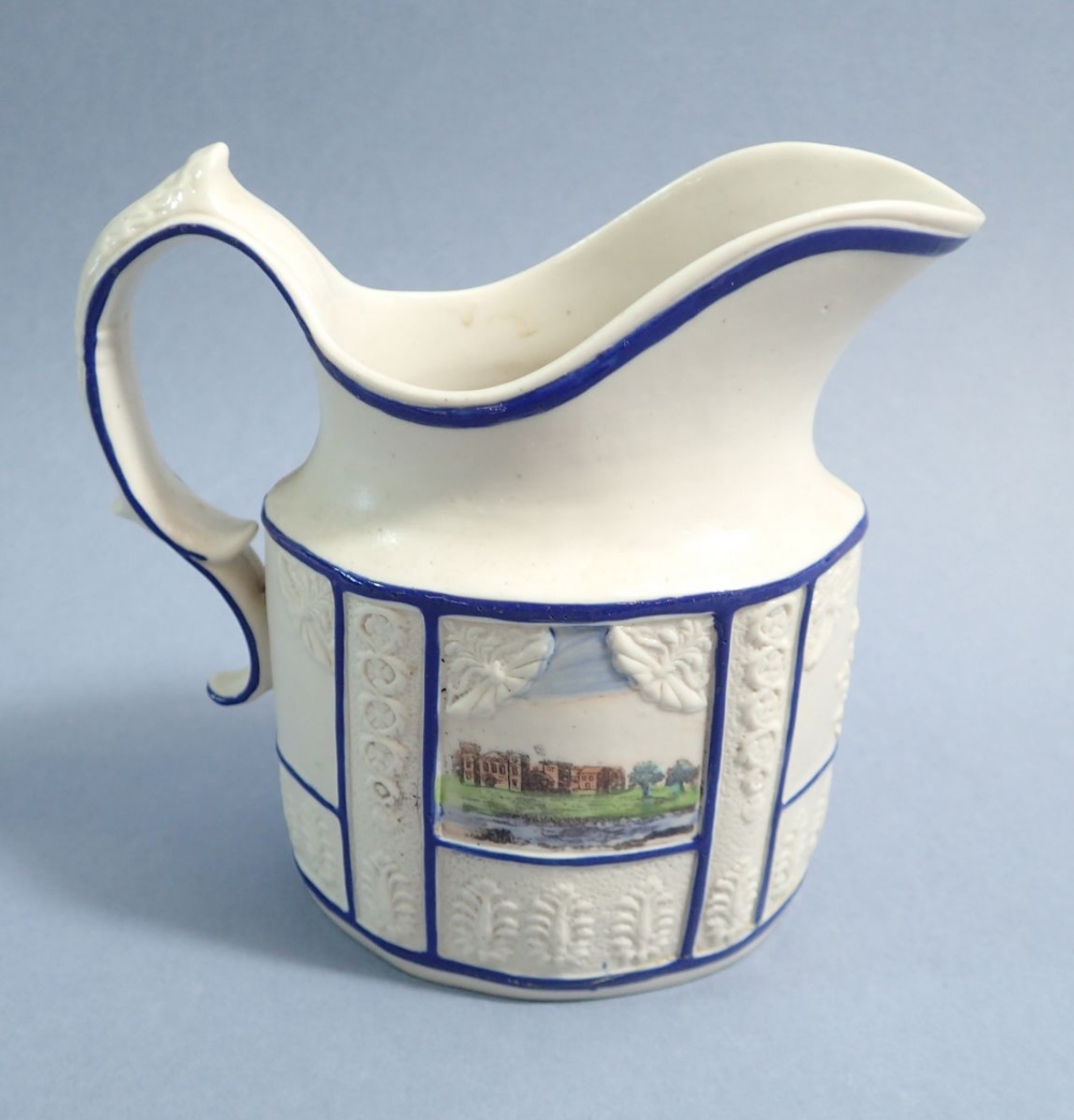 An early 19th century press moulded jug with blue lined panels and two printed country house scenes, - Image 2 of 2
